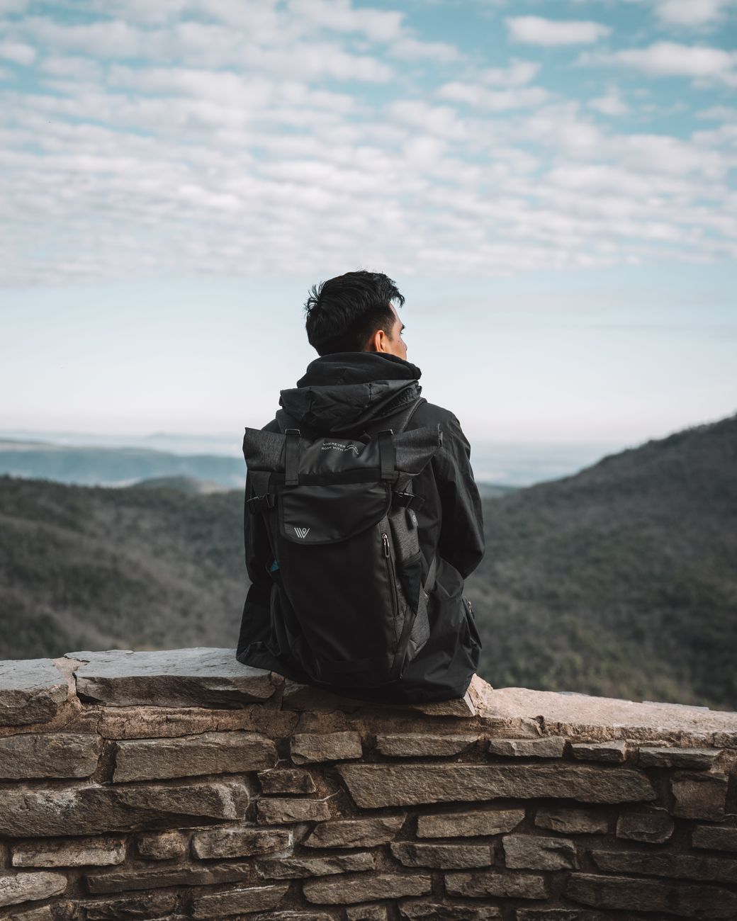 Journalist looking over mountain pass